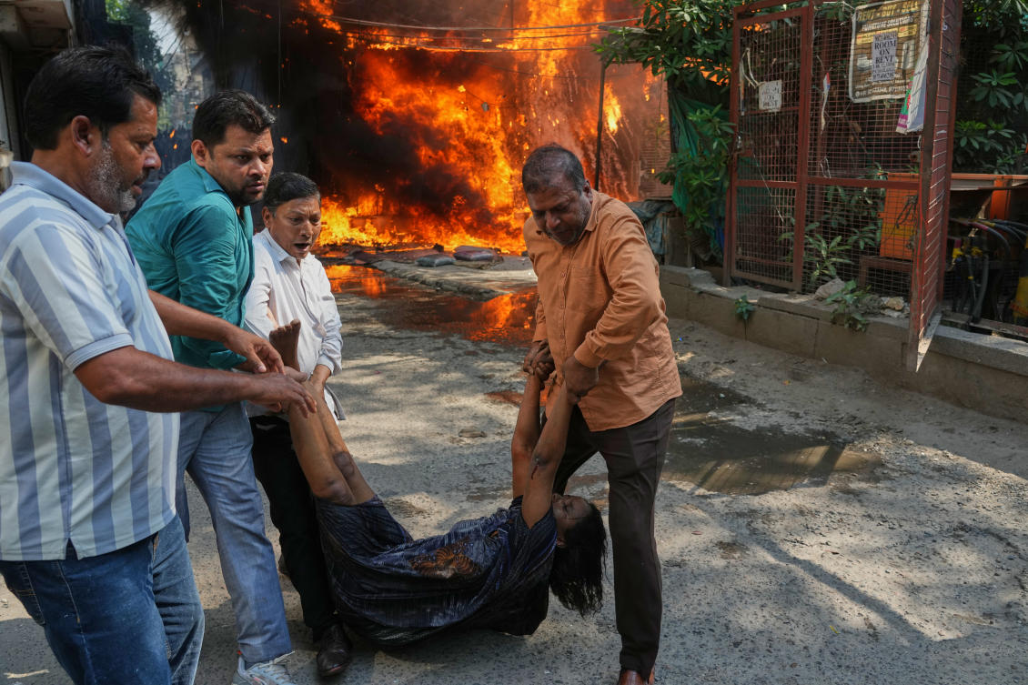 Residents rescue a foreign national from a hotel fire in New Delhi, India on June 3, 2026. (AP)