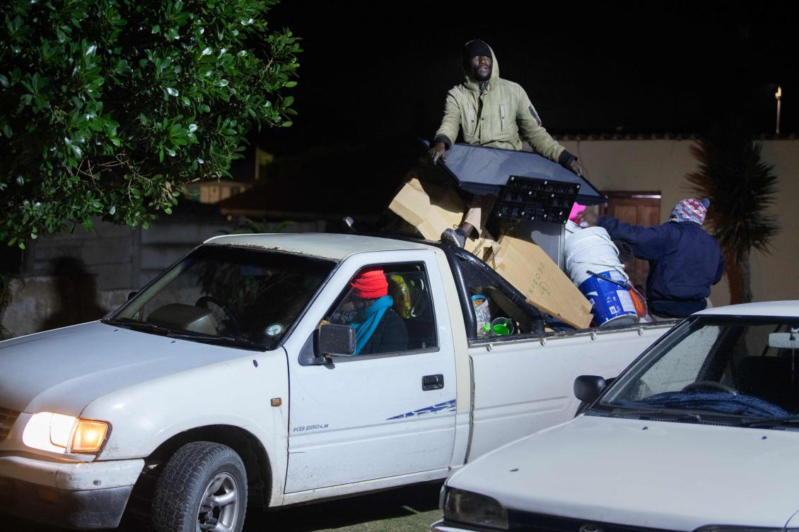 Immigrants arrive with their belongings at a community hall to take refuge in Gansbaai, about 140km from Cape Town, on June 2, 2026. (AFP)
