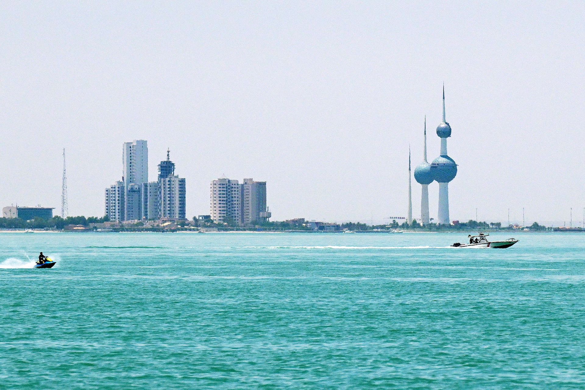 Boats sail past the Kuwait Towers as pictured from across the waterfront along the Gulf in Salimiyah on June 2, 2026. (AFP)