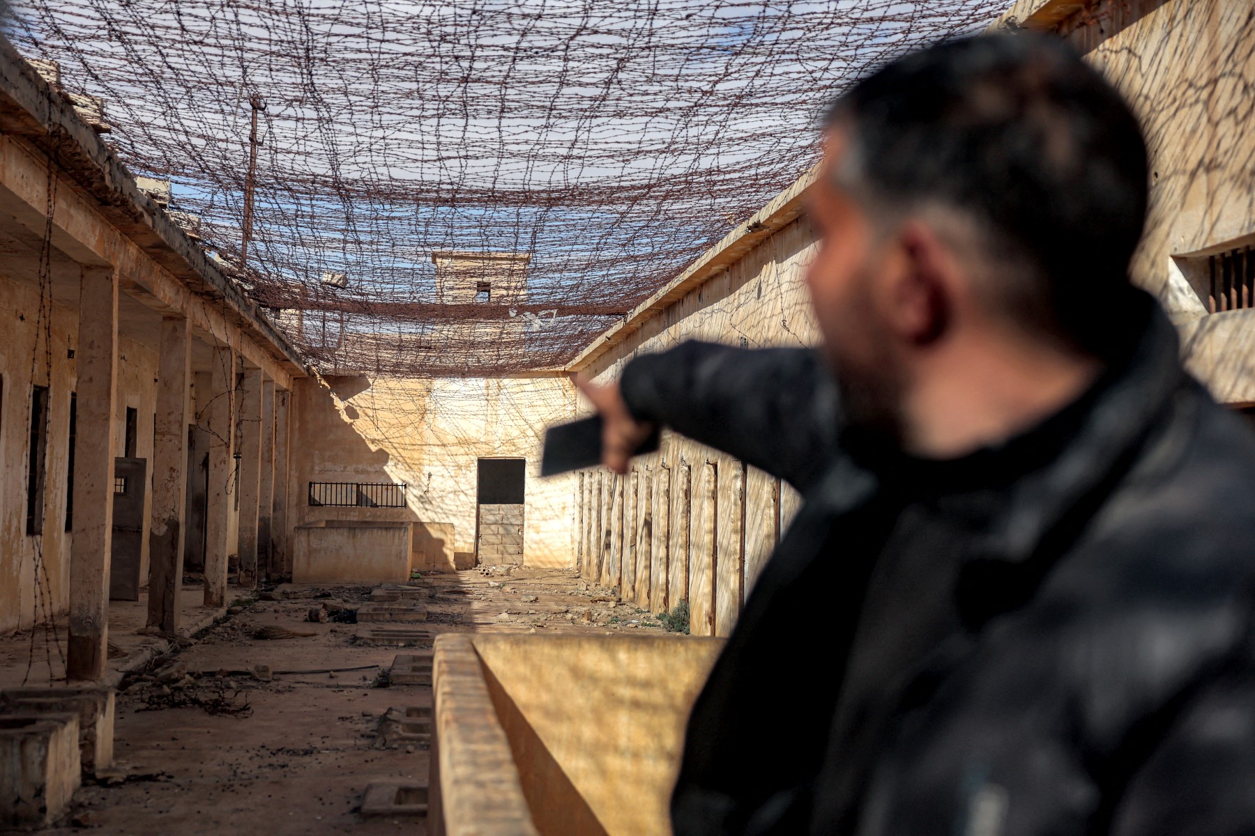 A local guides journalists visiting the Palmyra Prison Complex formerly used by the ousted Assad government in Syria's central city of Palmyra, Feb. 7, 2025. (AFP)