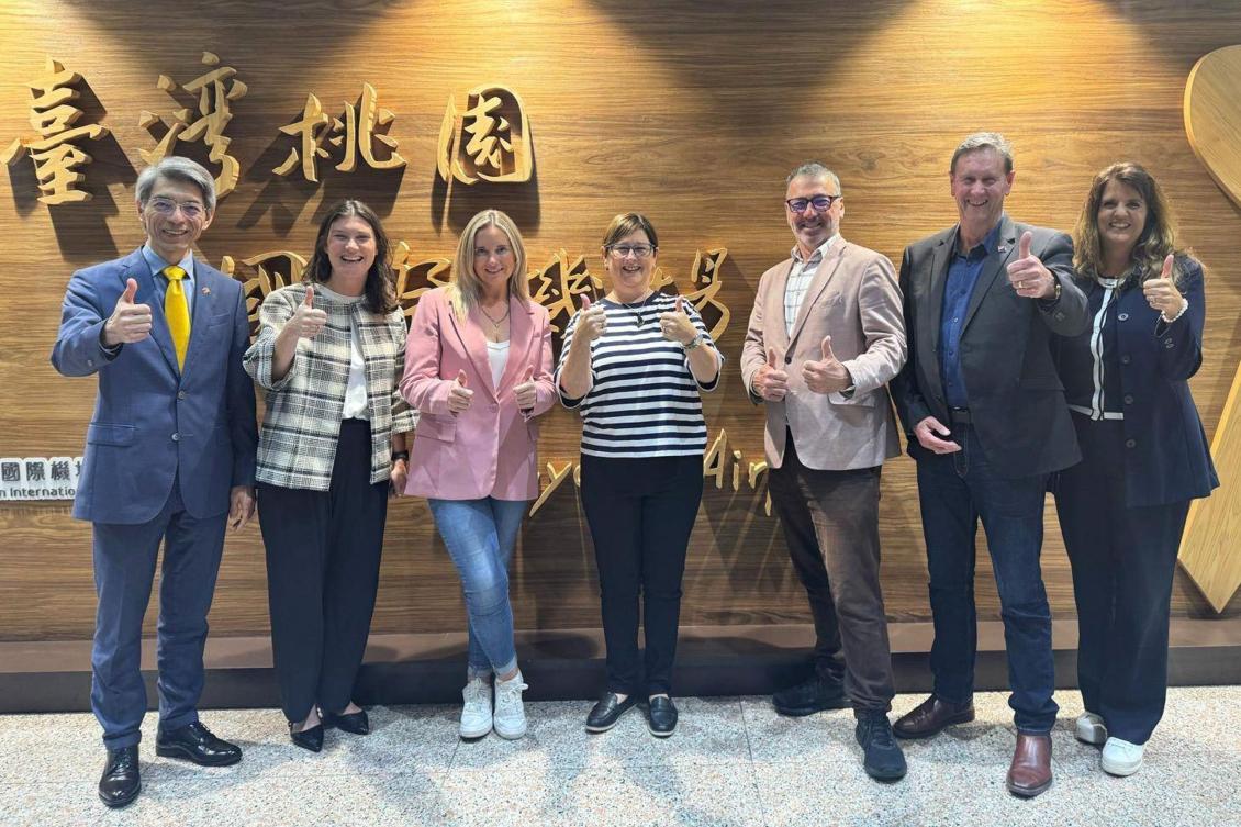New Zealand lawmakers Maureen Pugh (C), Duncan Webb (3rd R), Laura McClure (3rd L) and David Wilson (2nd R) posing for a group photo at Taiwan Taoyuan International Airport in Taoyuan. (AFP)