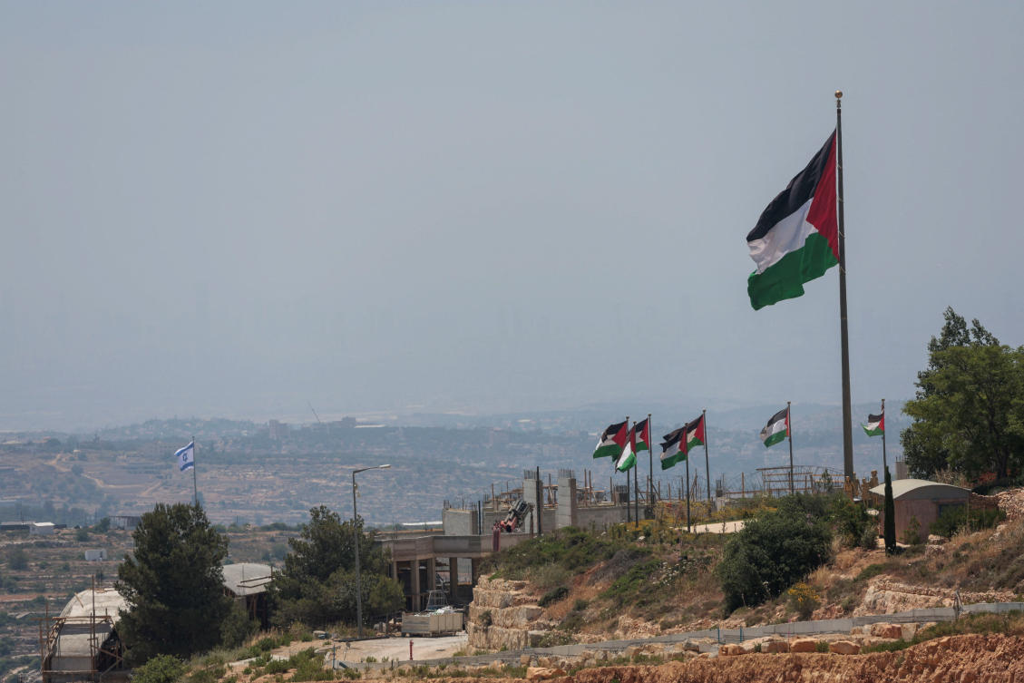 An Israeli flag flutters at a new Israeli settlement, behind Palestinians flags near Ramallah, in the Israeli-occupied West Bank, Jun 1, 2026. (REUTERS)