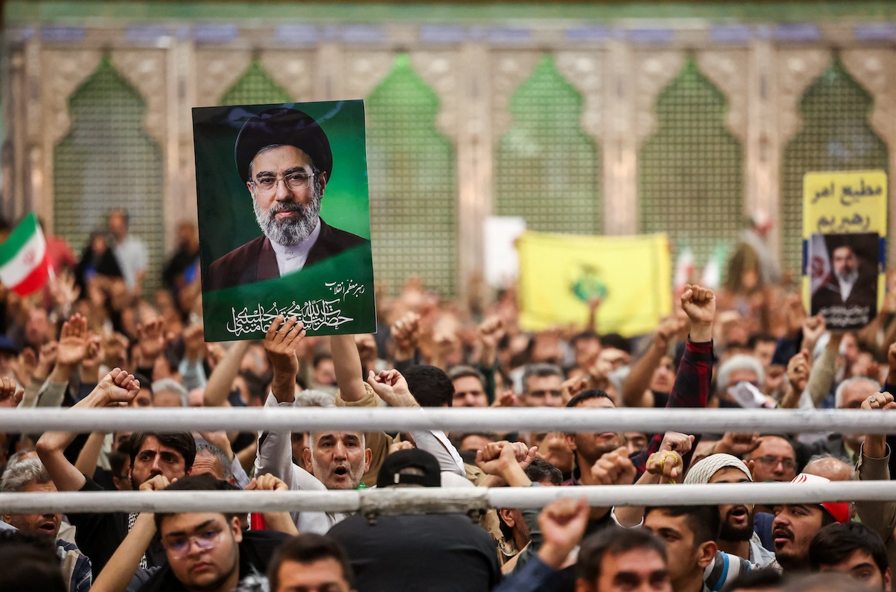 Man holds a placard with an image of Iran’s Supreme Leader Mojtaba Khamenei during a ceremony for the 37th anniversary of the death of Ayatollah Ruhollah Khomeini, in southern Tehran, Iran June 4, 2026. (Reuters)