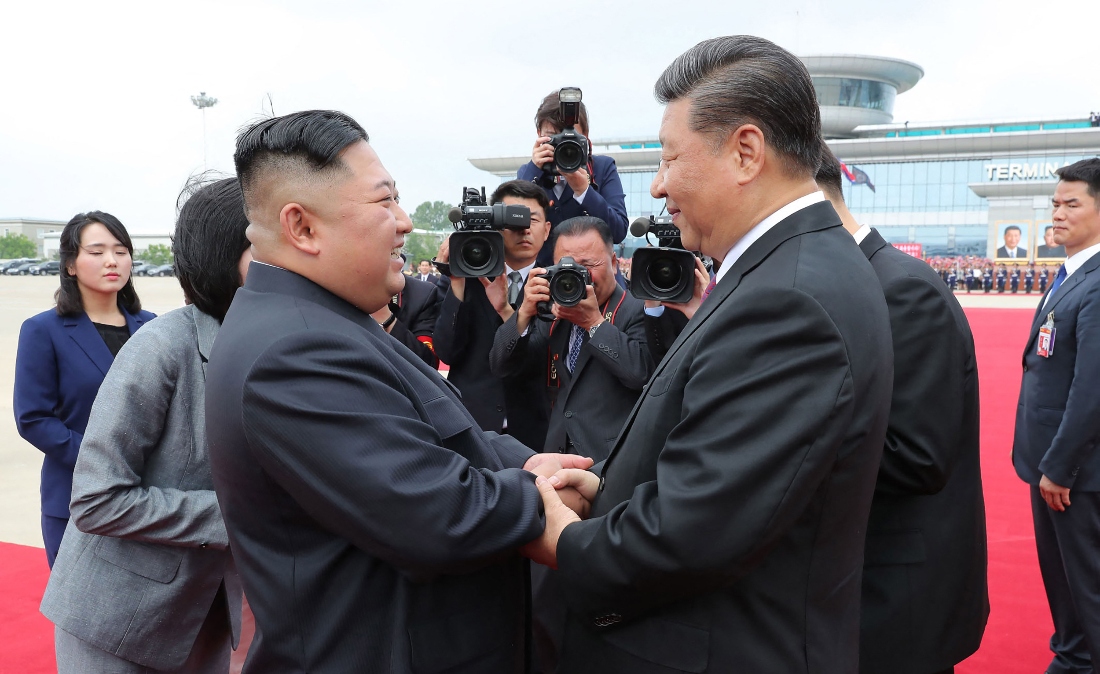 China's President Xi Jinping speaking with North Korean leader Kim Jong Un upon his departure at the airport in Pyongyang, North Korea. (KCNA)