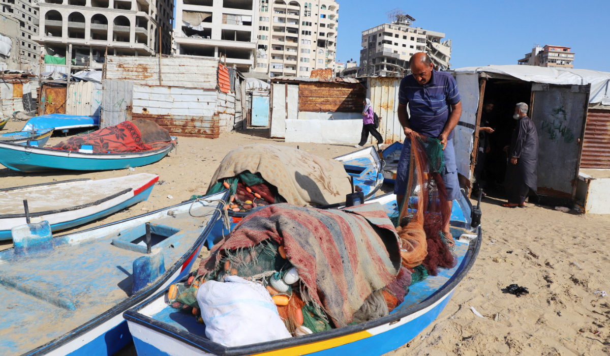 A Palestinian fisherman checks his net on the beach in Gaza City, June 3, 2026. (REUTERS)