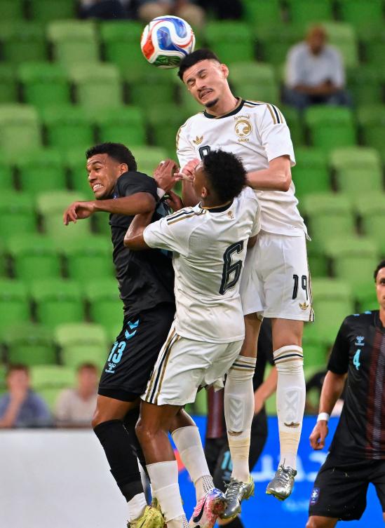 Saudi Arabia's Abdullah Alhamddan (19) and Nasser Aldawsari (6) jump for the ball against Puerto Rico's Gerald Diaz (13) during the second half of an international friendly soccer match, Friday, June 5, 2026, in Austin, Texas. (AP Photo/Darren Abate)