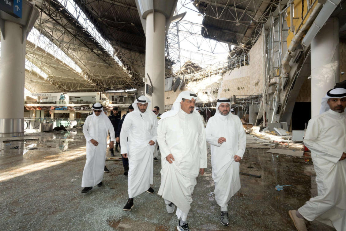 Kuwaiti officials inspect damage inside a terminal at Kuwait International Airport following a drone and missile attack on June 3, 2026. (Kuwait News Agency/Handout via Reuters)