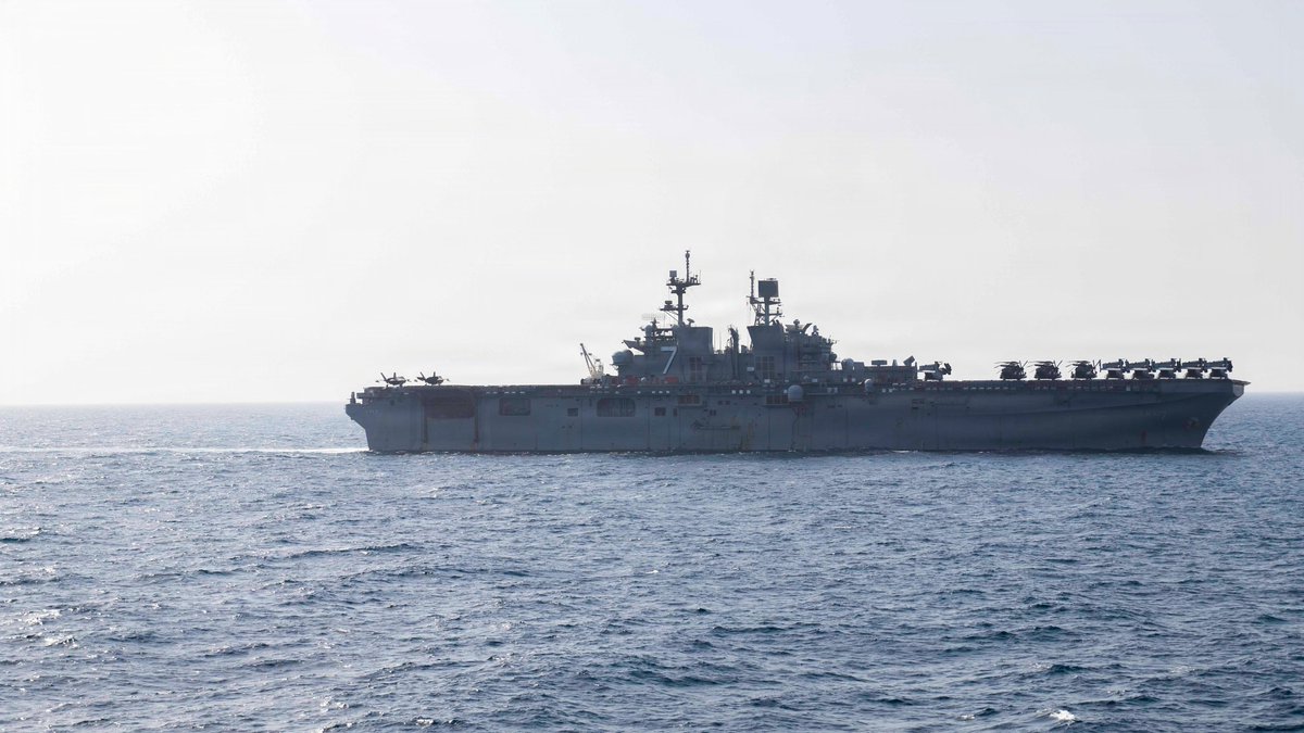 Above, the USS Tripoli transits the Arabian Sea as it supports the ongoing US blockade against Iran. (X: @CENTCOM)