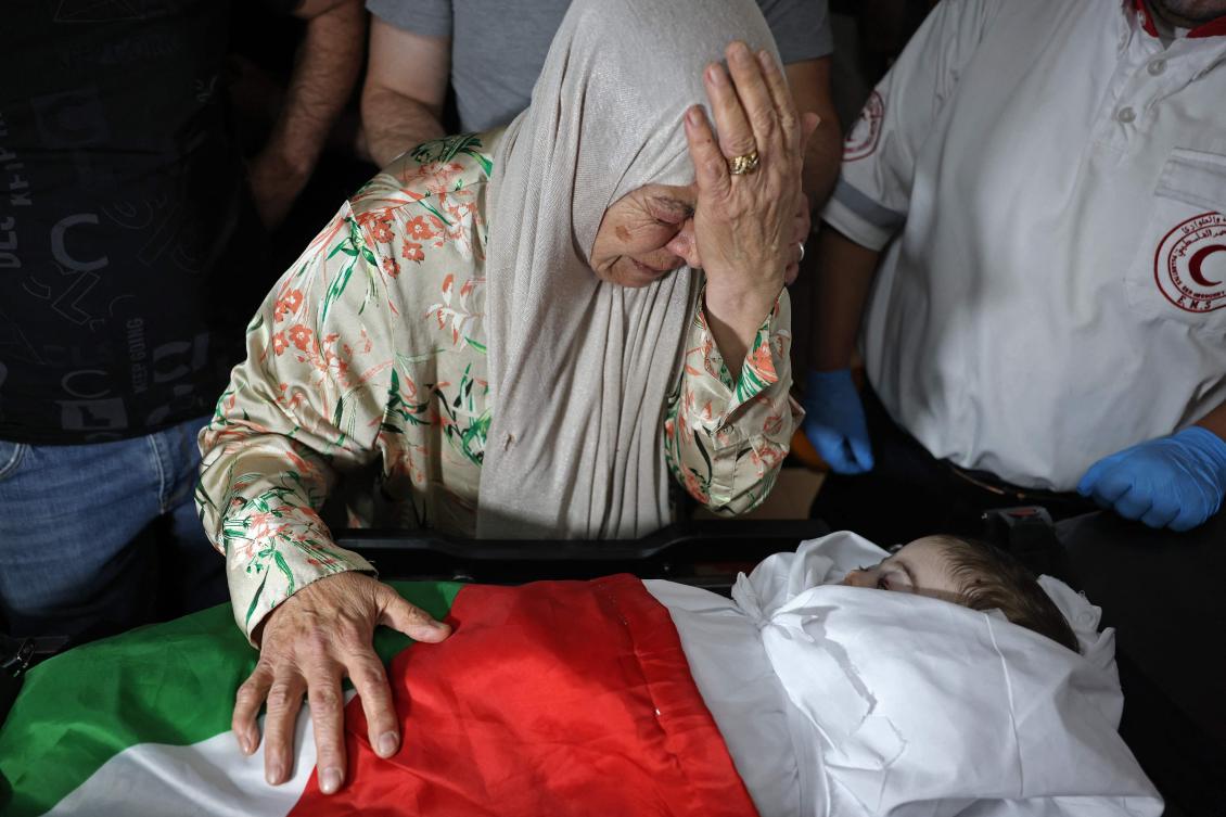 Firyal Abou Haikal, the grandmother of seven-month-old Sam Fahd Abou Haikal, weeps over his body at a hospital in Hebron, in the occupied West Bank on June 6, 2026. (AFP)
