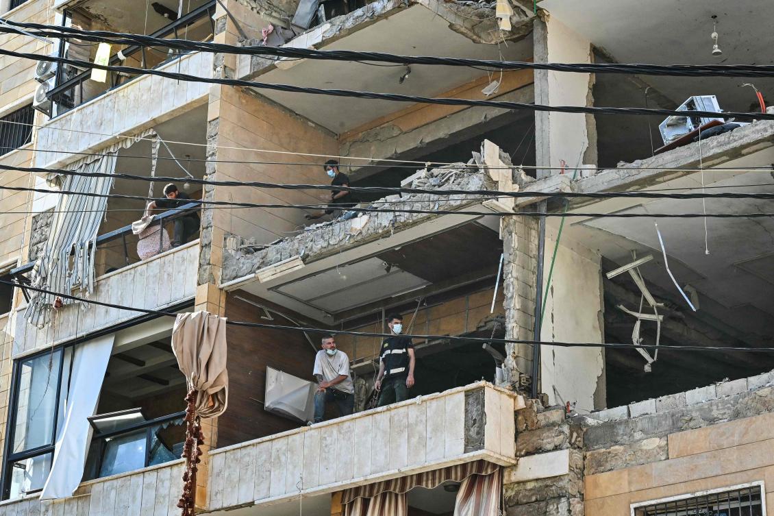 First responders inspect damage at the site of an Israeli airstrike targeting apartments in a residential building in Beirut’s southern suburbs on June 7, 2026. (AFP)