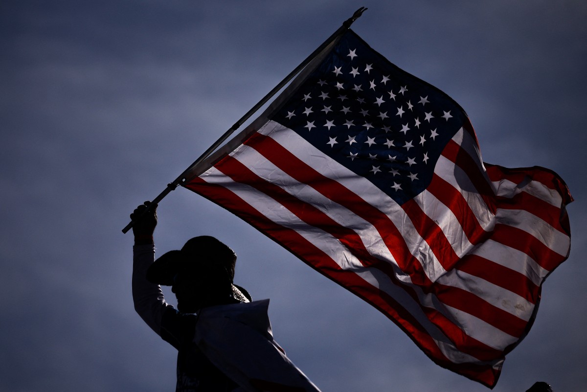 A fan waves an American flag during the NASCAR Cup Series FireKeepers Casino 400 at Michigan International Speedway, US. (AFP)
