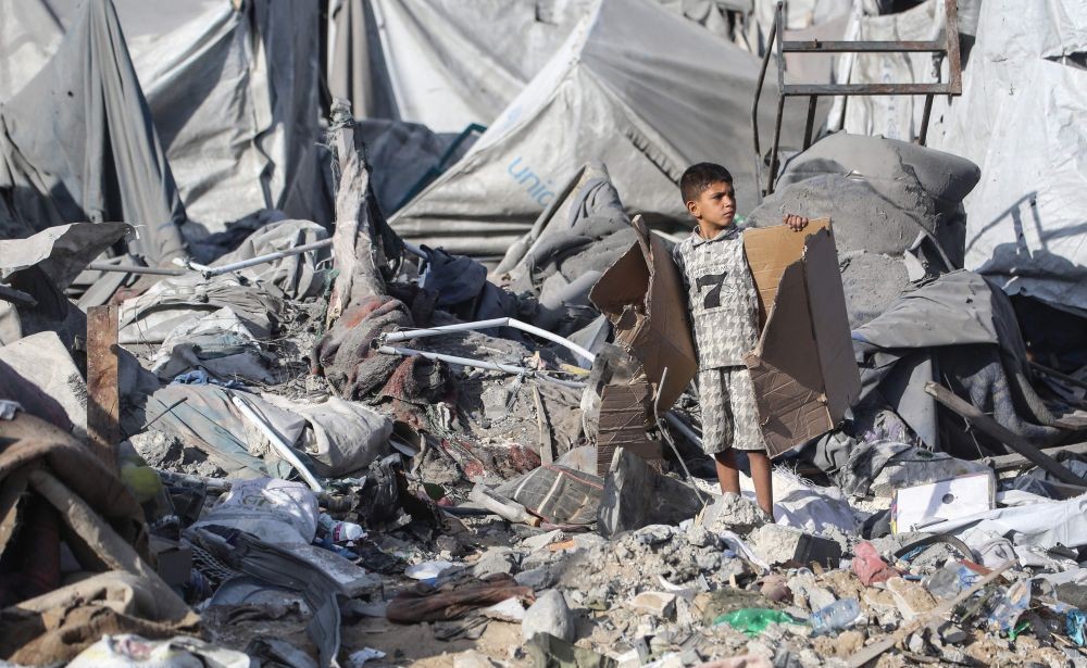 A Palestinian boy stands amid debris at the site of an Israeli airstrike in Khan Yunis, southern Gaza Strip, on June 7, 2026. (AFP)