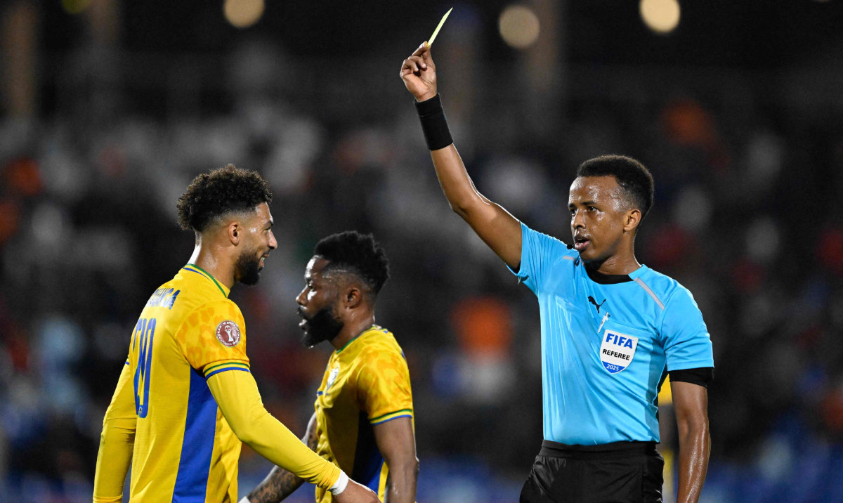 Gabon's forward #20 Denis Bouanga is shown the yellow card by Somali referee Omar Abdulkadir Artan during the Africa Cup of Nations (CAN) Group F football match between Gabon and Ivory Coast at the Grand Stadium in Marrakech on December 31, 2025. (AFP)