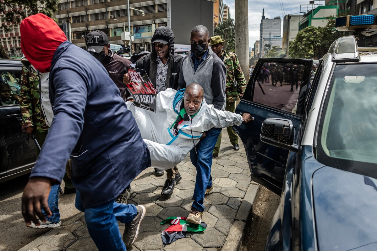 An activist reacts while being arrested by plainclothed Kenyan police officers during a protest against a US-built Ebola quarantine centre in Nairobi, Kenya. (AFP)