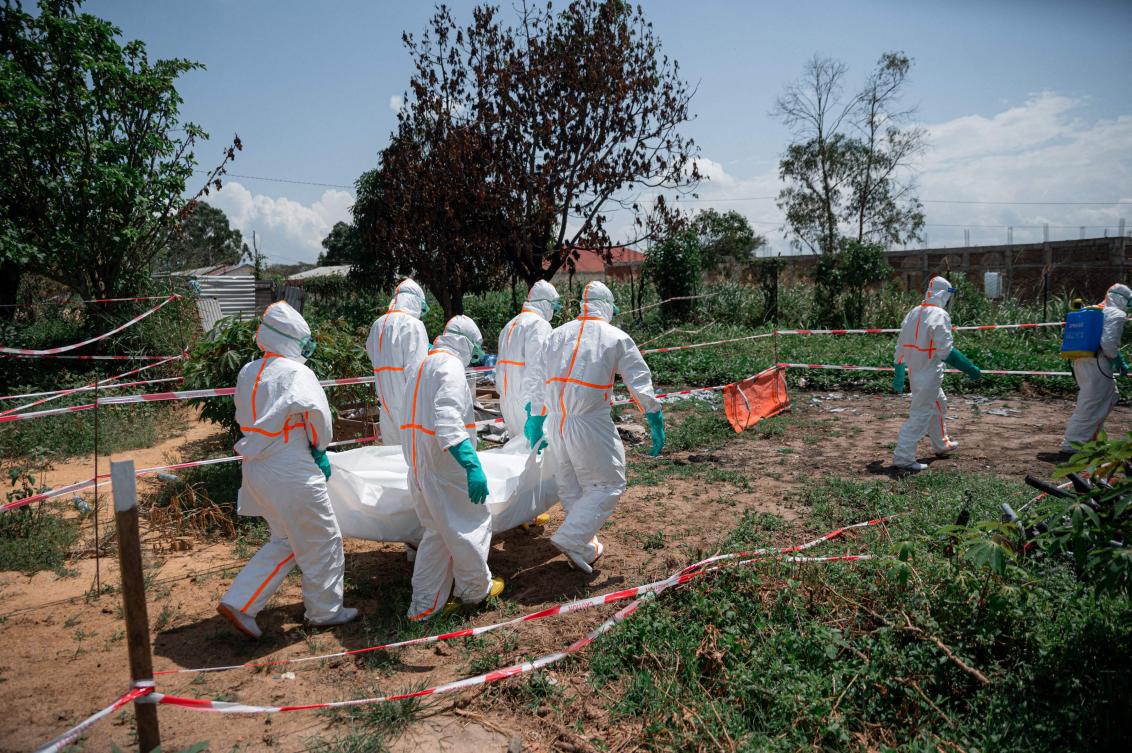 Volunteers of the Democratic Republic of Congo Red Cross wearing personal protective equipment carry the body of an Ebola virus disease victim from the morgue of the Rwampara health centre, Ituri Province, Democratic Republic of Congo, on June 8, 2026. (AFP)