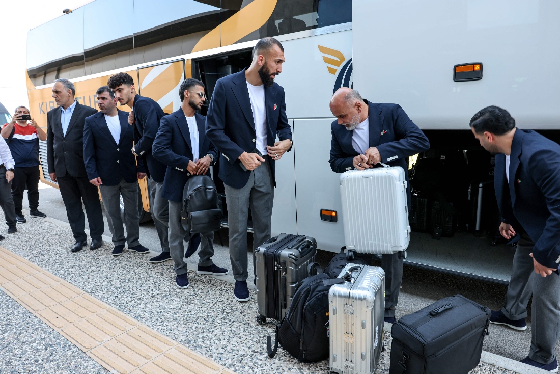 Rouzbeh Iran's midfielder #15 Roozbeh Cheshmi and Iran's midfielder #10 Mehdi Ghayedi descend from a bus as the Iranian national football team arrives at Antalya Airport, Turkiye. (AFP)