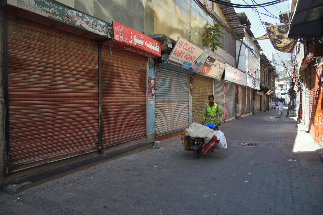 Local residents walk through a closed market during a strike called by an outlawed alliance of activist groups "Joint Awami Action Committee" (JAAC) demanding greater political rights and the abolition of 12 legislative refugee seats, in Muzaffarabad, the capital of Pakistan-administered Kashmir, Tuesday, June 9, 2026. (AP)