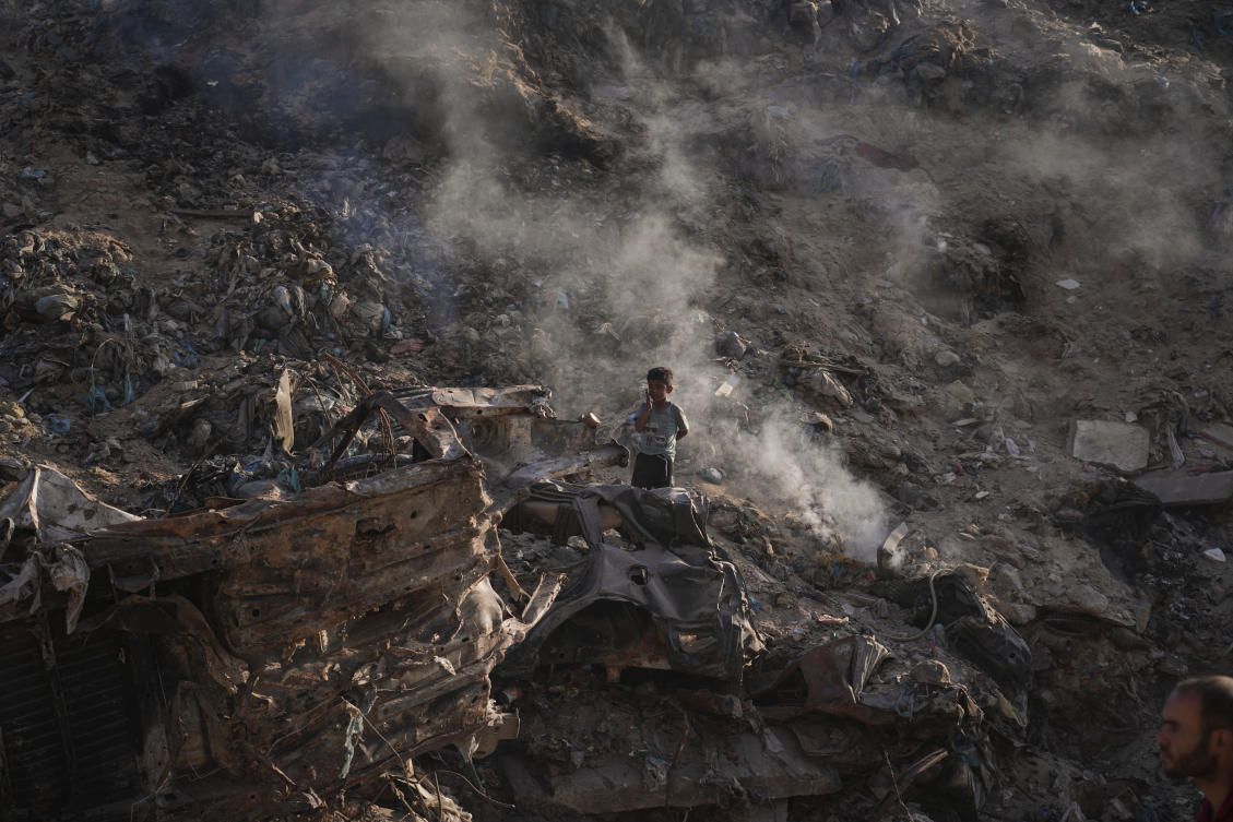 A child searches for plastic at a landfill in Gaza, on Monday, where Israel continues to carry out daily attacks despite a ceasefire agreement. (AP)