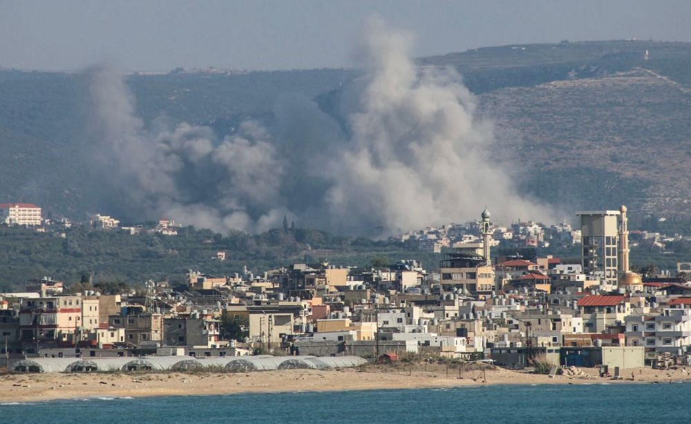 A photograph taken from the southern area of Tyre shows smoke rising from the sites of Israeli airstrikes on the village of Al-Qlaileh on June 10, 2026. (AFP)