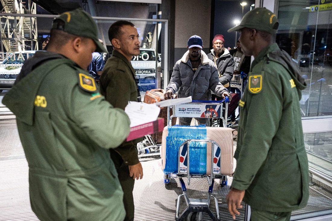 South African Border Management Authority officials control a Nigerian national’s documents at the OR Tambo International Airport, in Johannesburg, South Africa. (AFP)