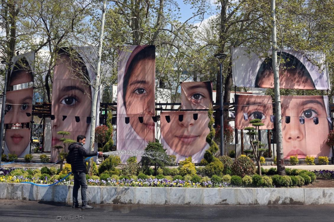 A gardener waters the plants in front of the portraits of children killed in a deadly strike on a children’s school in the southern city of Minab on the first day of the war that killed at least 165 people, most of them children, at the Tajrish Square in Tehran on April 16, 2026. (FILE/AFP)
