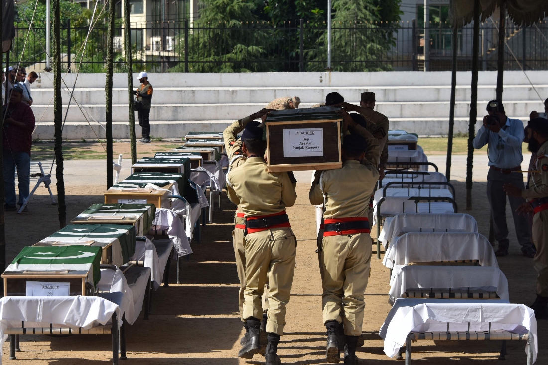 Pakistani soldiers carry the coffins during funeral prayers for personnel who were killed in Pakistan military helicopter crash in Muzaffarabad, Pakistan. (AFP)