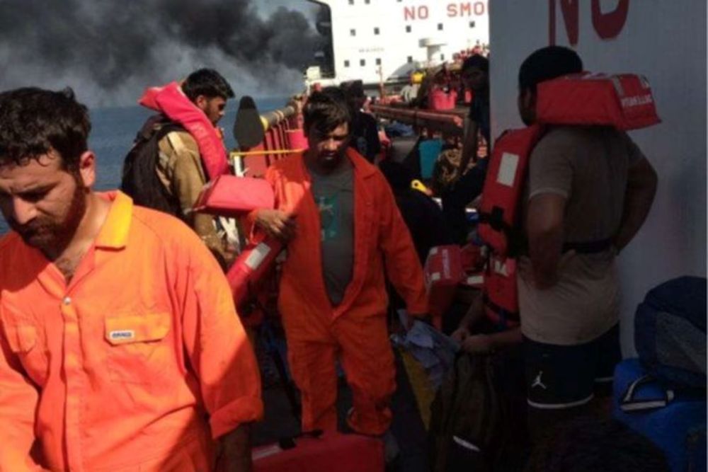 In this photo shared by the vessel's manager IOS Marine on June 11, 2026, US attack survivors are seen evacuating the burning MT Settebello. (IOS Marine)