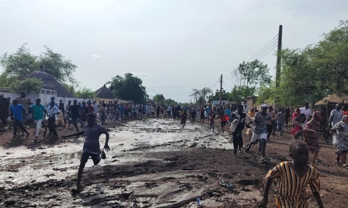 Sudanese run after hearing the noise of an explosion, reportedly from a drone that crashed, near the local government headquarters, in the Friendship neighbourhood of the city of Gedaref, eastern Sudan. (File/AFP)