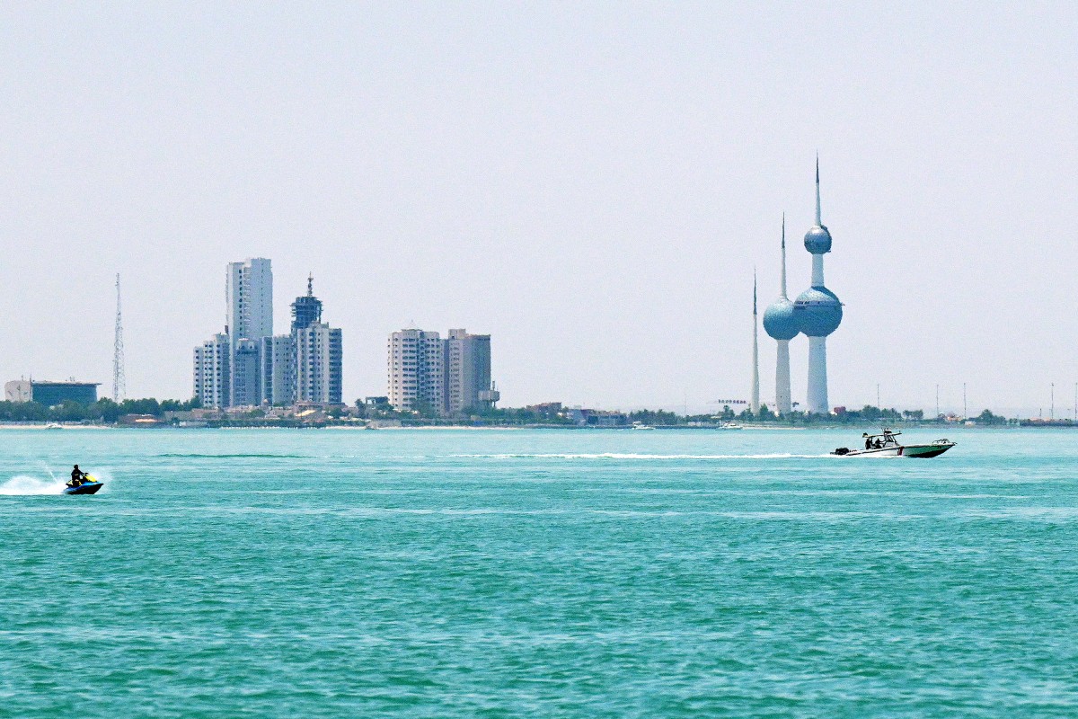 Boats sail past the Kuwait Towers as pictured from across the waterfront along the Gulf in Salimiyah, June 2, 2026. (AFP)