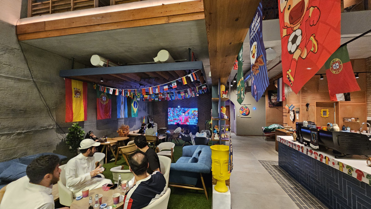 Local cafes in Saudi Arabia are decorated with national flags and football-themed buntings as fans gather to watch World Cup matches. (Supplied)