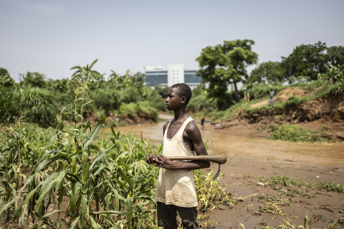 Yacouba Amadou, 15 years old worker, poses for a photograph in a urban farm in Abuja Central Business District, Nigeria. (AFP)