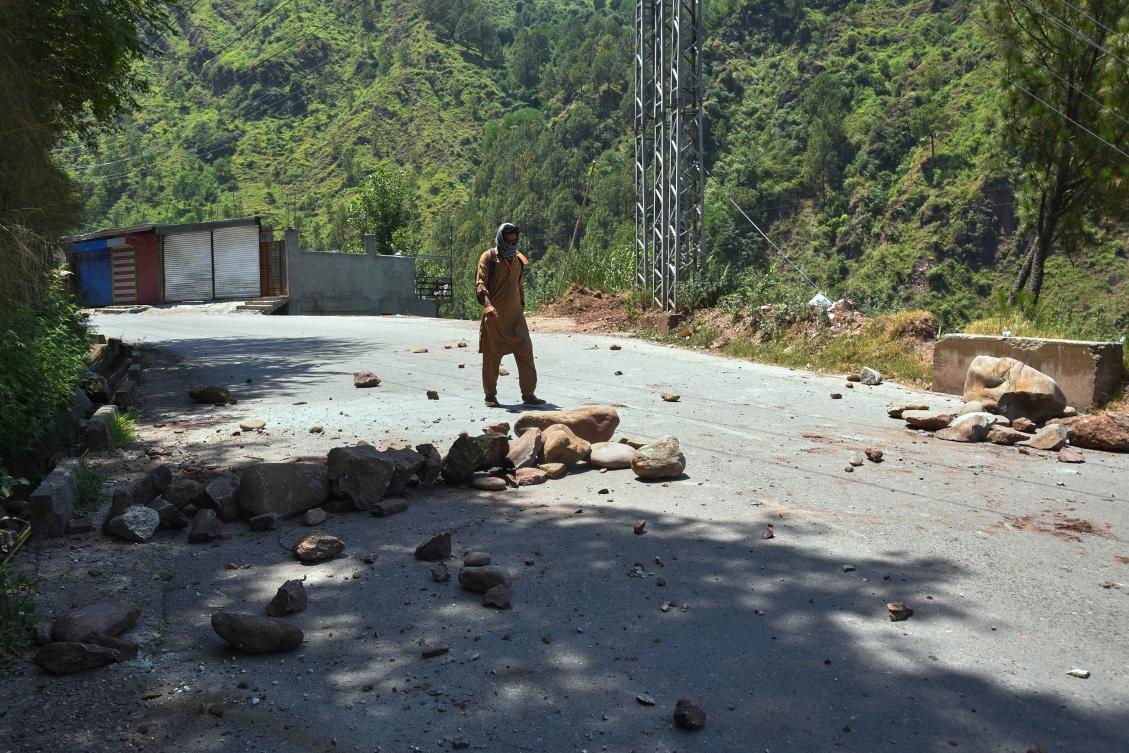 A local resident walks through a road barricaded with stones by protesters during a strike on the outskirts of Muzaffarabad, the capital of Pakistan-administered Kashmir, Tuesday on June 9, 2026. (AP)