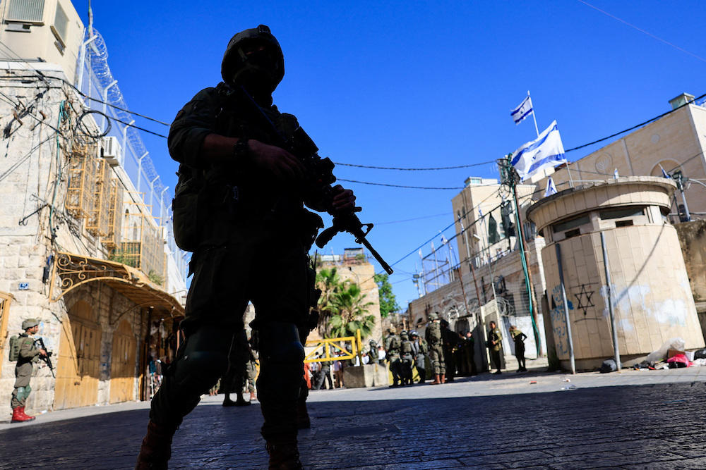 Israeli soldiers keep watch during a weekly settlers' tour in Hebron, in the Israeli-occupied West Bank, June 13, 2026. (Reuters)