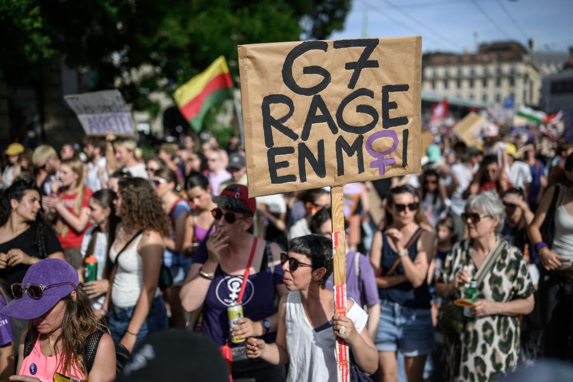 A protester holds a placard reading “G7: rage inside me” during a feminist strike against patriarchy and the upcoming G7 summit in nearby Evian, in Lausanne. (AFP)