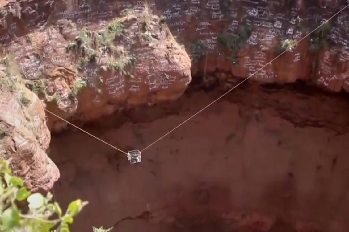 This screengrab from video, released by Yemeni Civil Defense Authority, shows rescuers removing the body of daredevil adventurer Al-Qaqa Ibn Antar on Saturday. (Yemeni Civil Defense Authority via AP)
