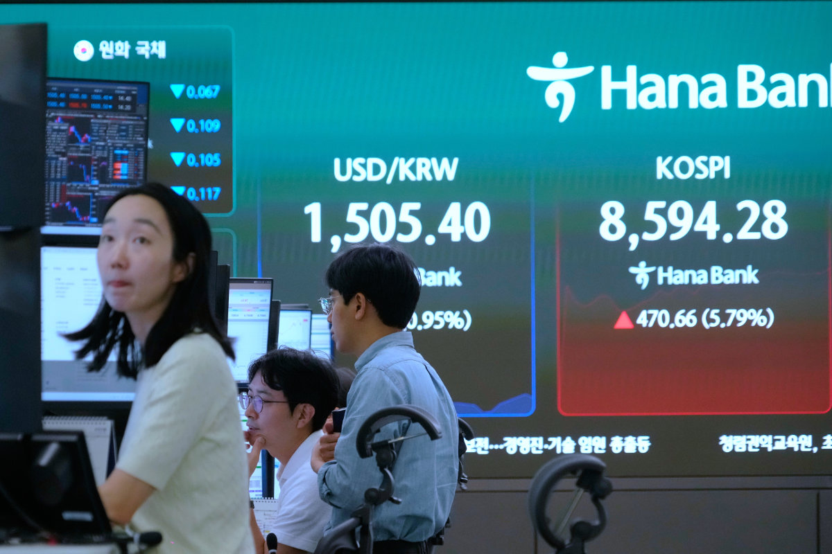 Currency traders watch monitors near a screen showing the Korea Composite Stock Price Index (KOSPI) and the foreign exchange rate between US dollar and South Korean won at the foreign exchange dealing room of the Hana Bank headquarters in Seoul, South Korea, Monday, June 15, 2026. (AP Photo)