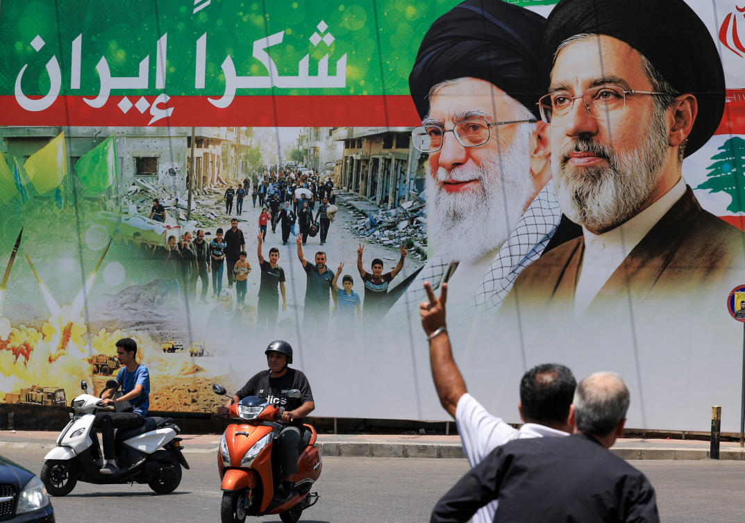 A man flashes a victory sign as he rides a motorcycle past a banner that reads "Thank you Iran" following a deal between the US and Iran, in the southern suburbs of Beirut, Lebanon, June 15, 2026. (REUTERS)