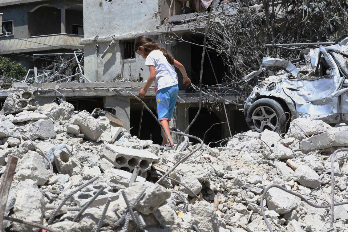 A displaced girl walks on top of her family's home, destroyed by the Israeli military, upon her return to their village in Deir Qanoun en Nhar, south Lebanon, on Monday. (AFP)