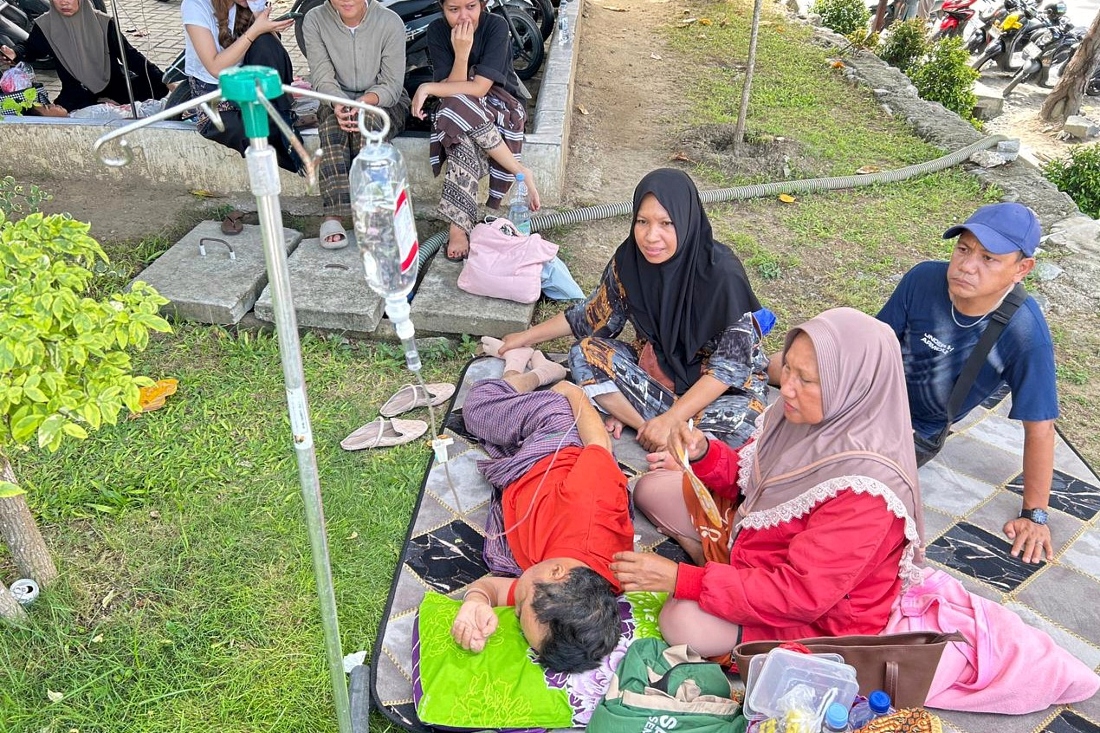 Patients who were evacuated are seen outside of a local hospital following an earthquake in Palu, Central Sulawesi, Indonesia. (AP)
