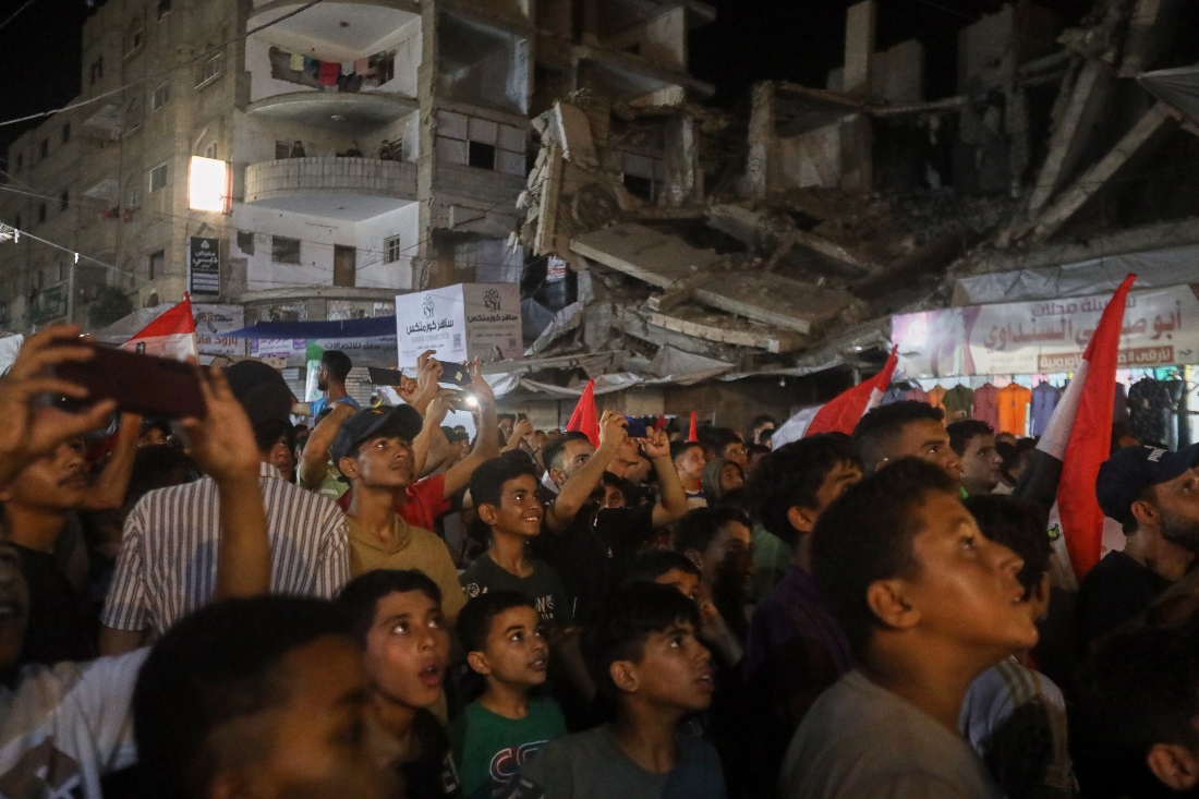 A crowd watches the Egypt-Belgium World Cup match on a giant screen in Nuseirat, central Gaza Strip. (AP)