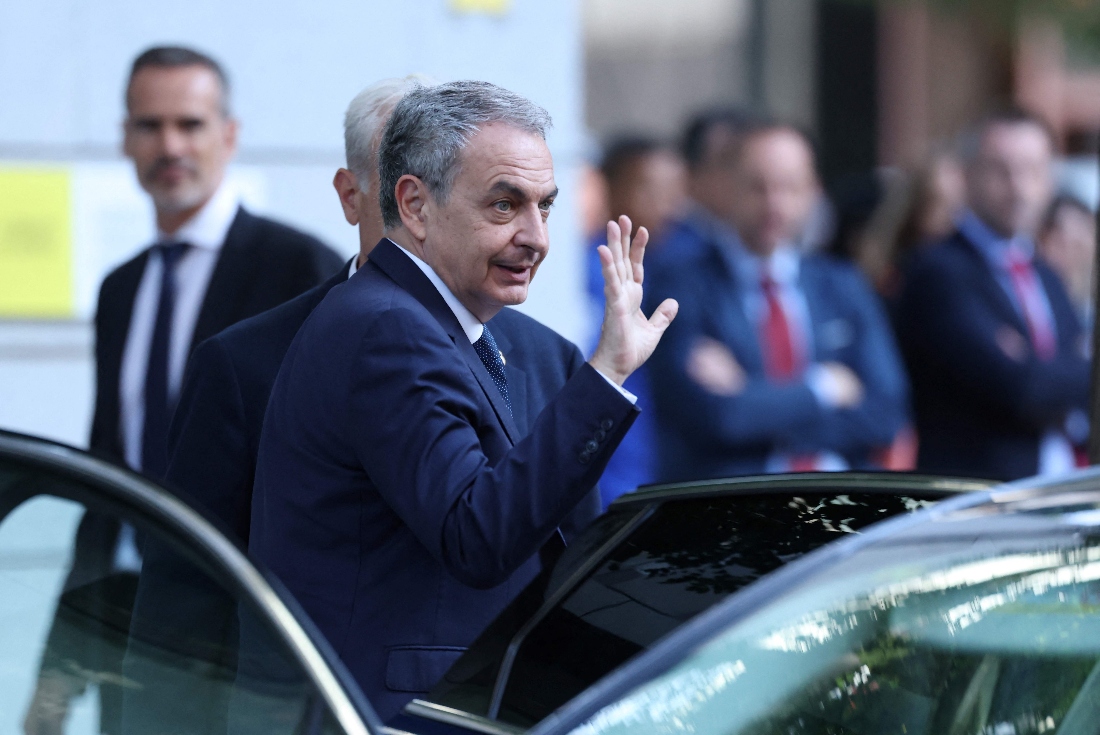 Spain's former Prime Minister Jose Luis Rodriguez Zapatero waves as he arrives to be questioned by a judge as part of an investigation for alleged influence peddling, at Madrid's Court in Spain. (AFP)