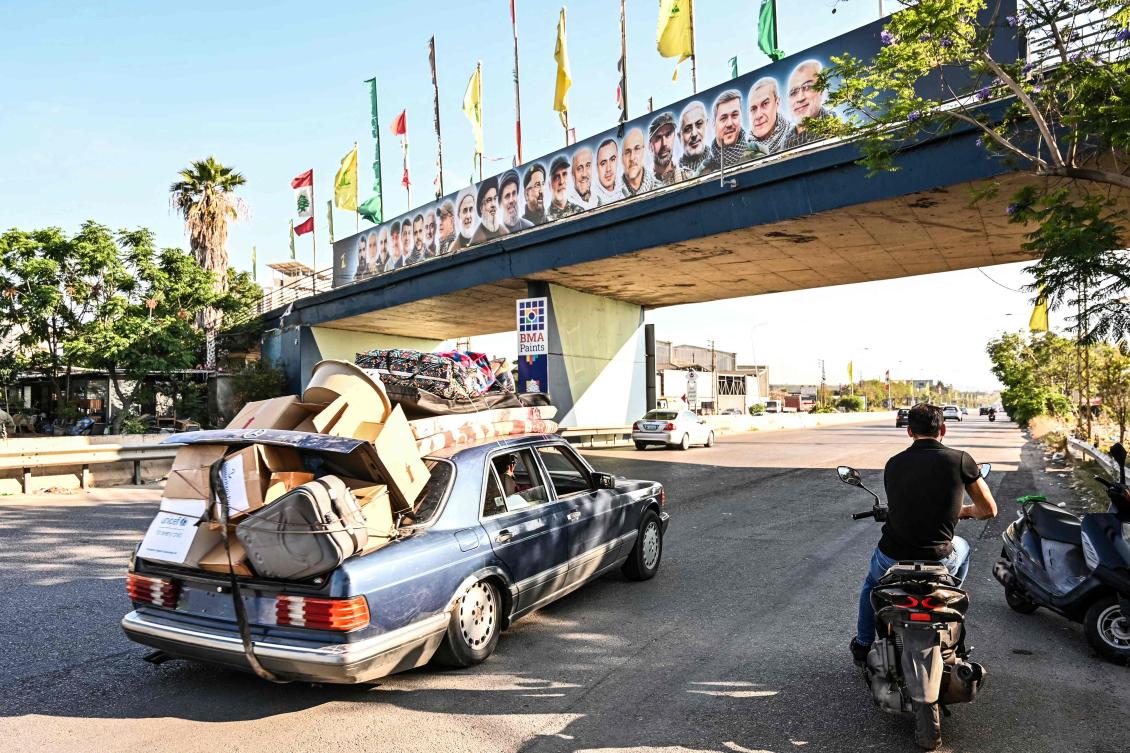 A car laden with house items drives along the highway through the area of of the coastal town of Ghazieyh as families return to their home villages in southern Lebanon on Jun. 15, 2026. (AFP)