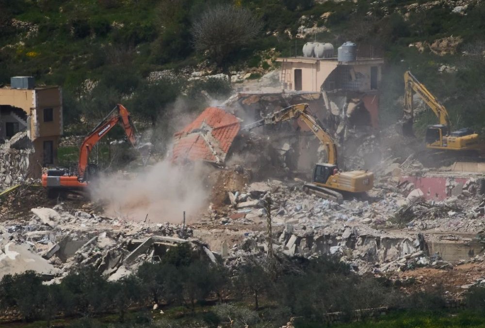 Bulldozers demolishing homes in southern Lebanon, as seen from northern Israel. (AP Photo)