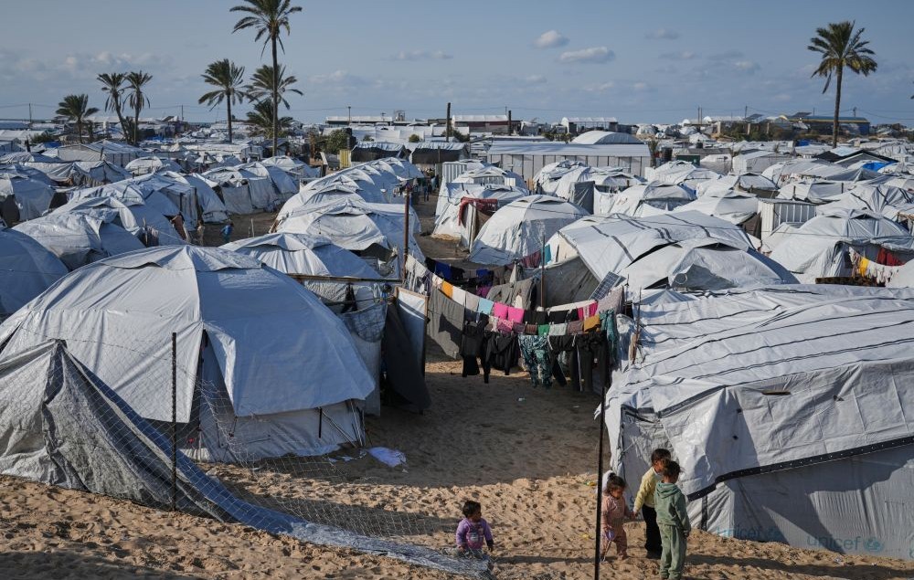 Palestinian children walk between tents at an orphanage camp in Khan Younis, southern Gaza Strip, Jan. 20, 2026. (AP Photo)