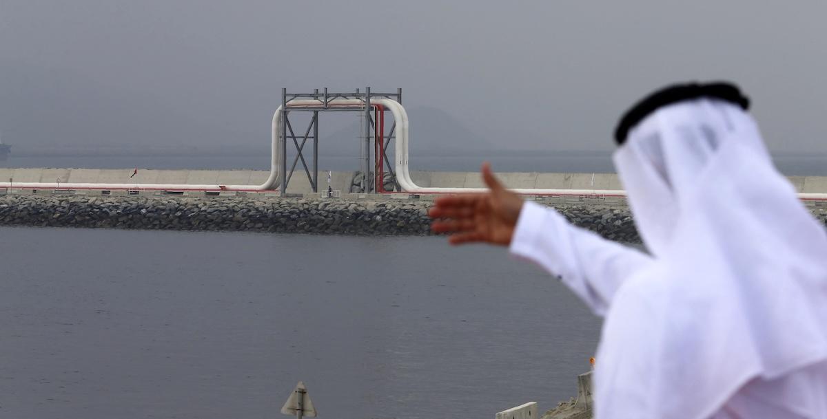 An Emirati man stands in front of a pipeline at the oil terminal of Fujairah during the inauguration ceremony of a dock for supertankers on September 21, 2016. (FILE/AFP)