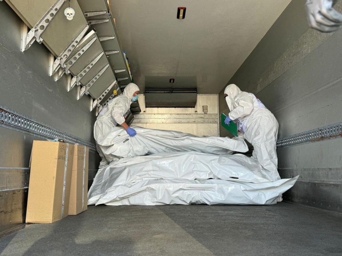 A photo dated August 2024, shows International Red Cross representatives checking body bags containing remains of servicemen during an exchange of bodies in an undisclosed location in Sumy region. (AFP)