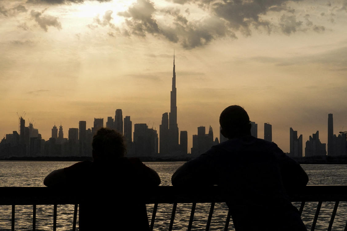 People watch the sunset over Dubai, with a general view of the Dubai skyline, including Burj Khalifa, center, on March 6, 2026. (Reuters)