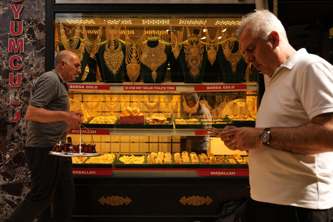 People walk past a gold business shop at the Grand Bazaar in Istanbul, Turkiye, Tuesday, June 16, 2026. (AP Photo/Francisco Seco)