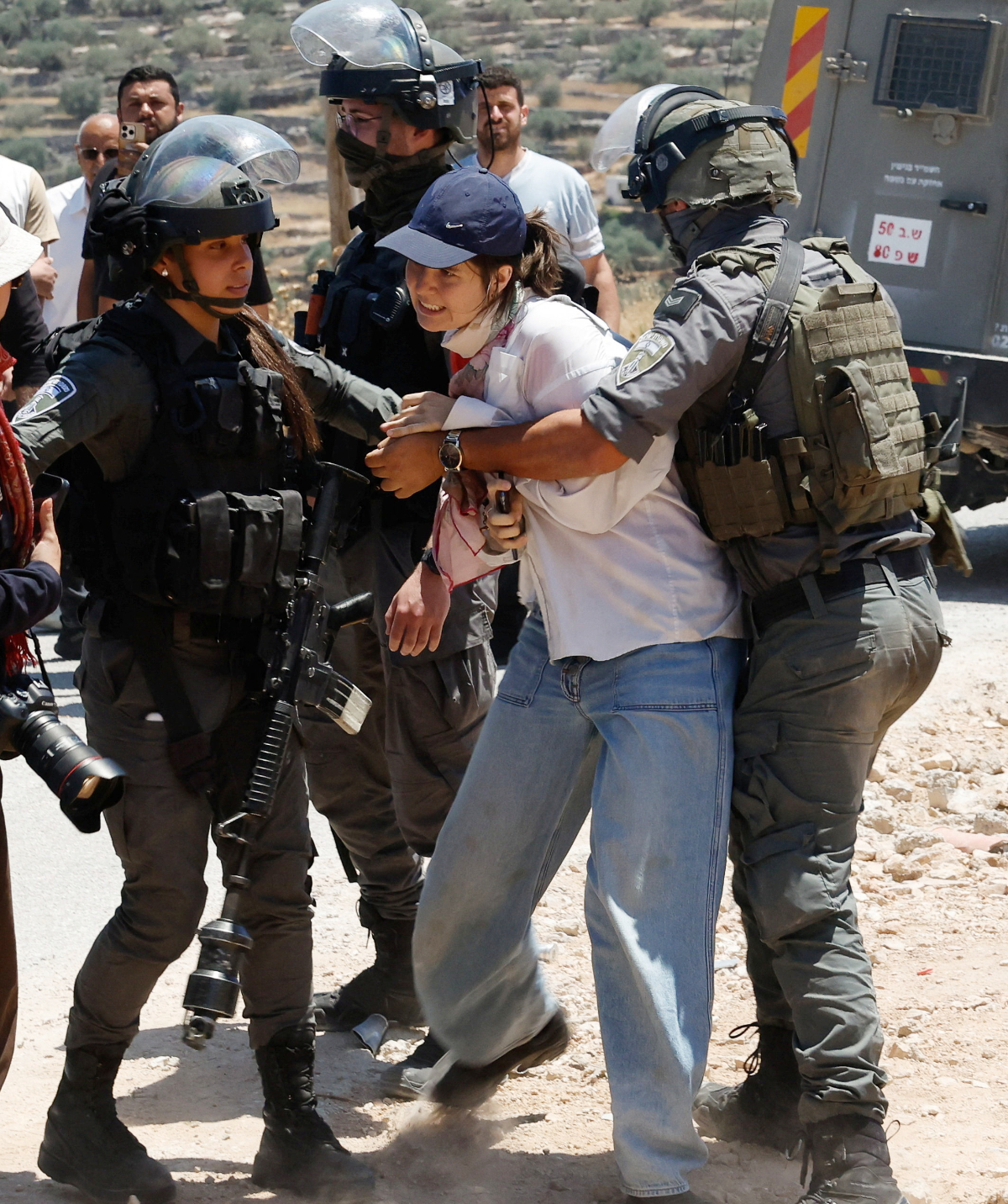 Israeli law enforcement officers detain an activist during a protest against a new Israeli settlement in the village of Deir Abu Mishal, near Ramallah, in the Israeli-occupied West Bank, June 19, 2026. (REUTERS)