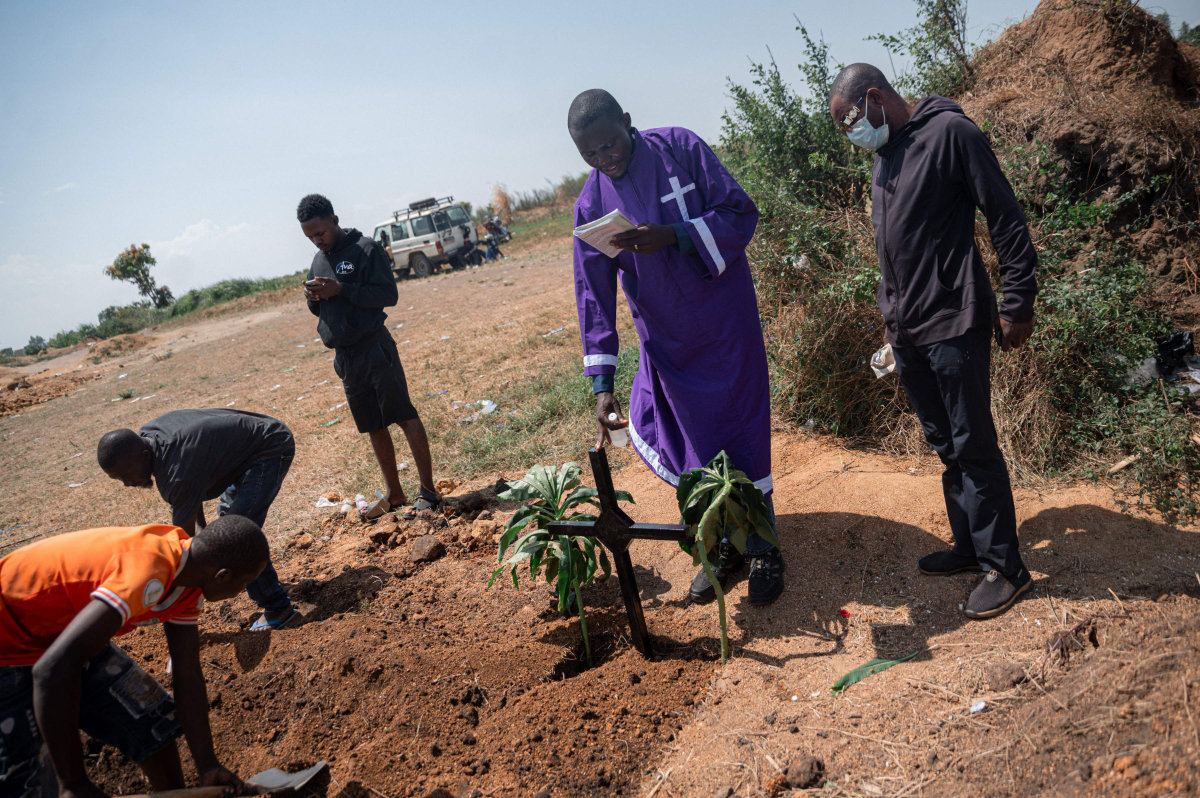 A priest conducts a blessing ceremony at Mbiyo cemetery for a fourth orphan who died from Ebola virus disease at an orphanage in Bunia, Ituri Province, June 19, 2026.(AFP)
